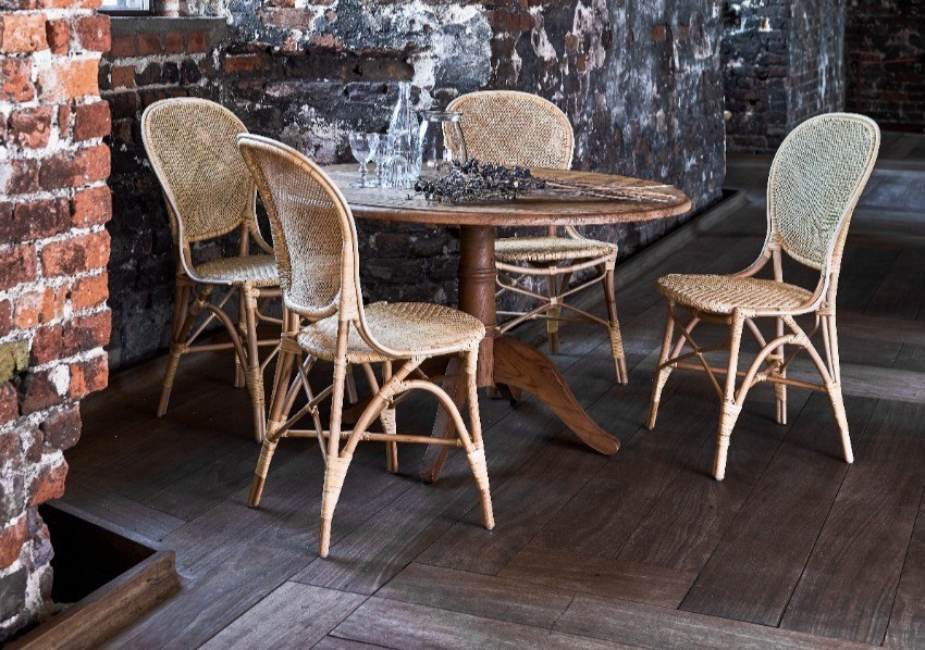 Intérieur loft style industriel avec guéridon bois et chaises rotin